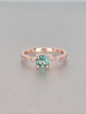 Rose Gold Ring with Green Center Stone and Leaf Accent Gems